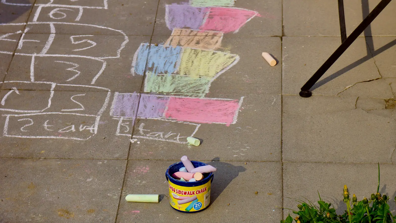 A hopscotch grid drawn in chalk on a pavement